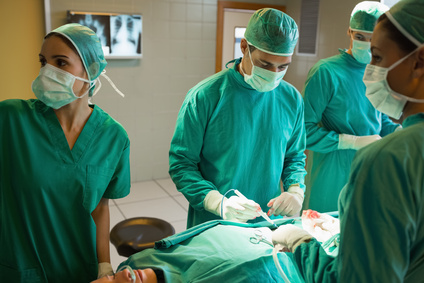 Team of surgeons working on the stomach of a patient in an operating theater